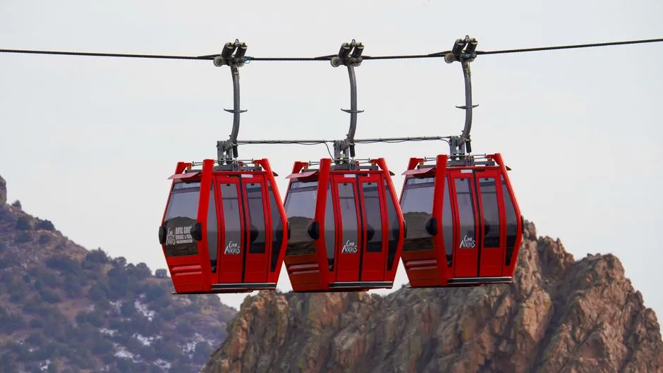 Cable car gondola rising over a mountain